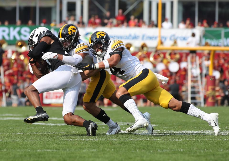 Iowa State Cyclones running back Breece Hall (28) is tackled by Iowa Hawkeyes linebacker Jack Campbell (31) and Iowa Hawkeyes linebacker Seth Benson (44) on Saturday, Sept. 11, 2021, at Jack Trice Stadium.