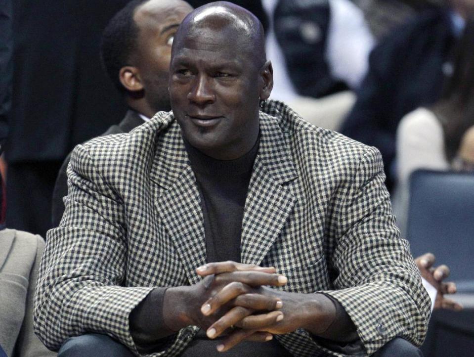 FILE - In this Jan. 14, 2012 file photo, Charlotte Bobcats basketball team owner Michael Jordan watches during the first half of an NBA basketball game between the Charlotte Bobcats and the Golden State Warriors in Charlotte, N.C. Tuesday, Aug. 7, 2012. President Barack Obama is joining with NBA legend Michael Jordan and an array of basketball stars to raise money for his re-election campaign later this month. The Obama campaign is planning a fundraising "shoot-around" and dinner in New York on Aug. 22 featuring several NBA stars. (AP Photo/Chuck Burton)