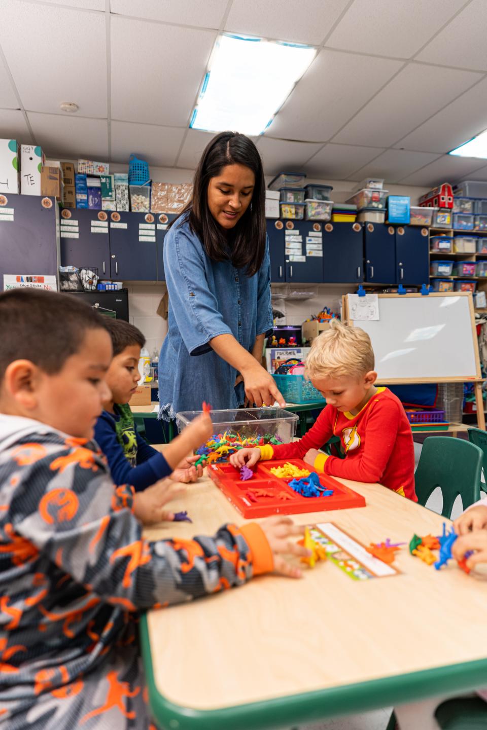Sarahi Garcia-Acosta, a pre-K teacher at Arthur Elementary School in the Oklahoma City district, directs her students as they use math manipulatives to understand important counting concepts. Through the online platform DonorsChoose, OG&E helped fund Garcia-Acosta's request for these critical classroom materials.