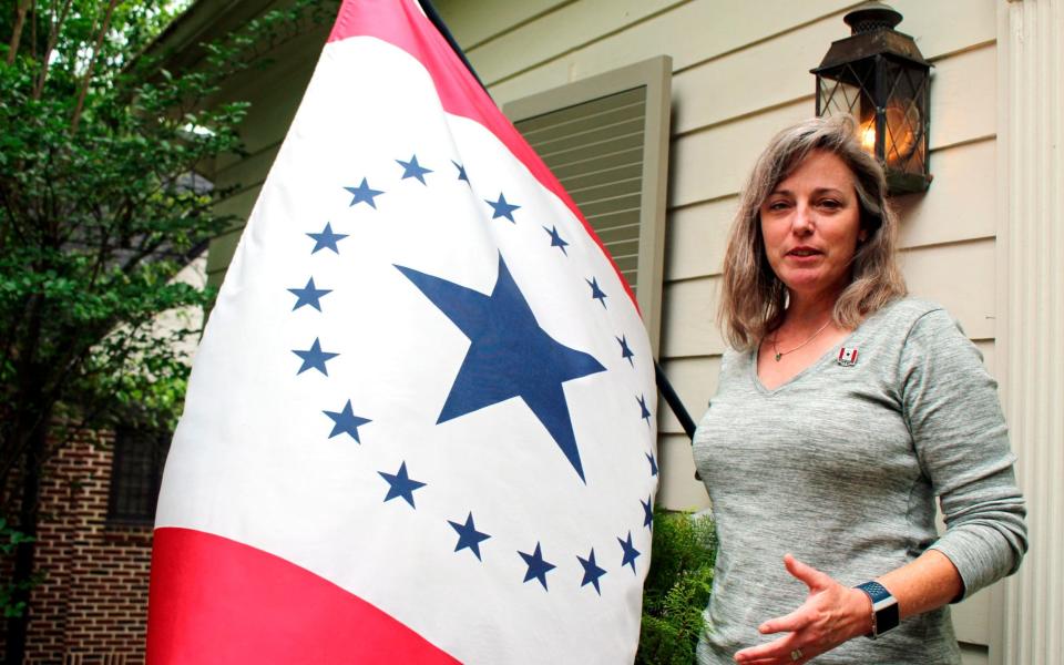 Laurin Stennis, an artist, speaks outside her home in Jackson, Miss., and explains how she thinks a flag she designed would be an appropriate symbol to replace the state flag - AP
