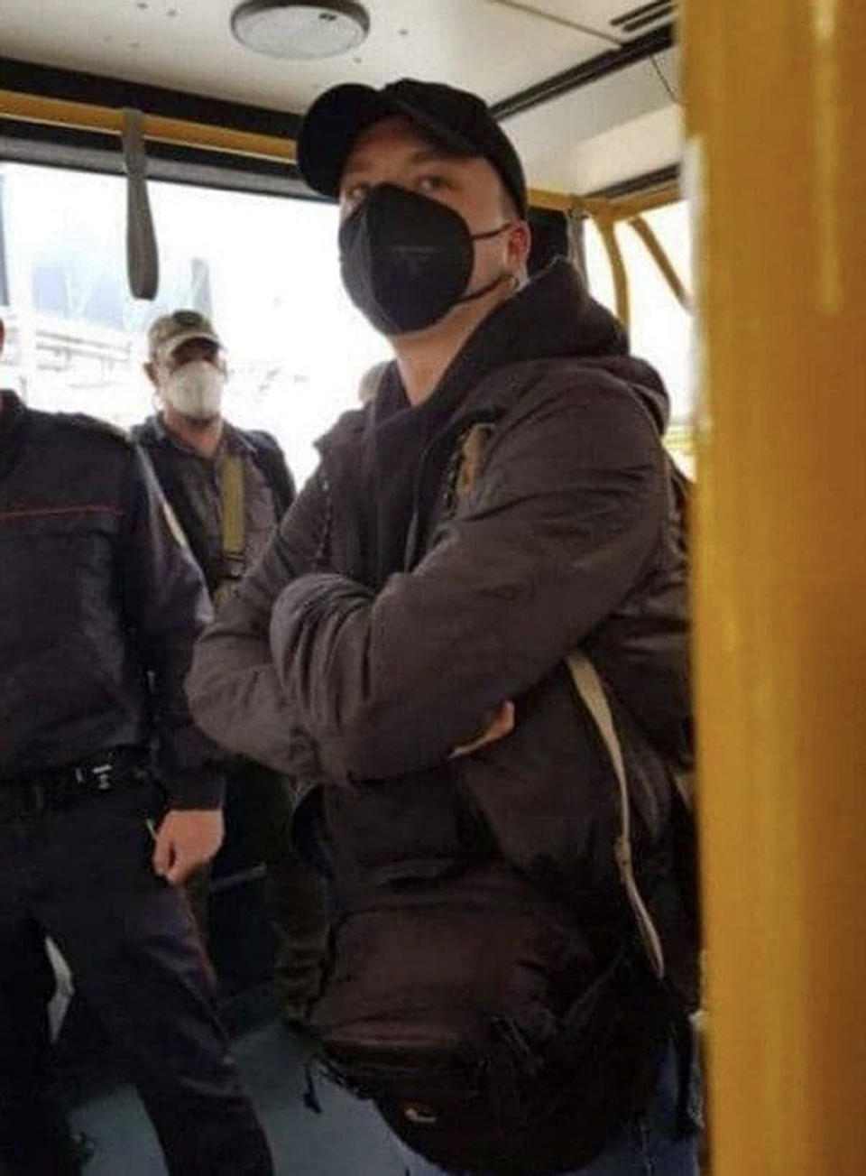 FILE - In this photo released May 23, 2021, by telegram Chanel t.me/motolkohelp, Belarus journalist Raman Pratasevich wearing a face mask, stands in an airport bus in the international airport in Minsk, Belarus. As he was returning Sunday to the Lithuanian capital of Vilnius from Greece with his girlfriend aboard a Ryanair jet, Belarusian flight controllers told the crew to divert to Minsk, citing a bomb threat. Pratasevich was arrested after the plane landed. (telegram Chanel t.me/motolkohelpp via AP, File)