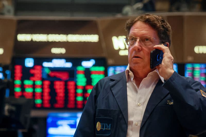 FILE PHOTO: Traders work on the floor of the NYSE in New York