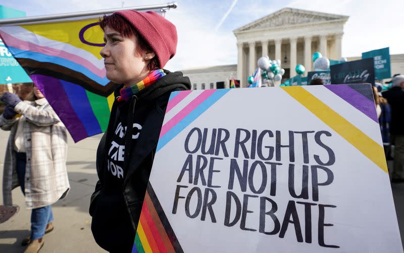 FILE PHOTO: Activists gather outside U.S. Supreme Court as justices hear arguments in case involving LGBT rights in Washington