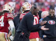 FILE - San Francisco 49ers defensive coordinator DeMeco Ryans celebrate on the sideline during the team's NFL football game against the Washington Commanders, Dec. 24, 2022, in Santa Clara, Calif. Detroit Lions offensive coordinator Ben Johnson, Ryans and Philadelphia Eagles offensive coordinator Shane Steichen are the finalists for AP Assistant Coach of the Year.(AP Photo/Scot Tucker, File)