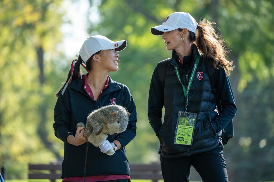 Columbus Academy's Angela Hu talks with coach Maggie Freytag during the state tournament on Friday.