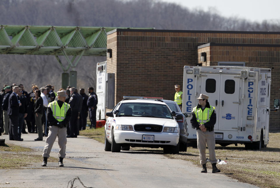 Washington Metro Police and cadets stand in Kenilworth Park in Washington, Monday, March 31, 2014. Police have been searching the park in northeast Washington since last week for clues in the case of eight-year-old Relisha Rudd, last seen in the company of Kahlil Tatum, a janitor at the homeless shelter where she lived with her mother and brothers.(AP Photo/Alex Brandon)