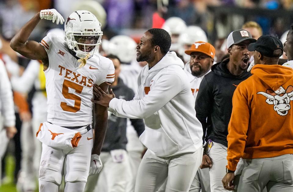 Texas wide receiver Adonai Mitchell celebrates his 35-yard catch for a first down that sealed the Longhorns' 29-26 win over TCU in Fort Worth. The catch came on the final drive of the game and converted a third-down play.