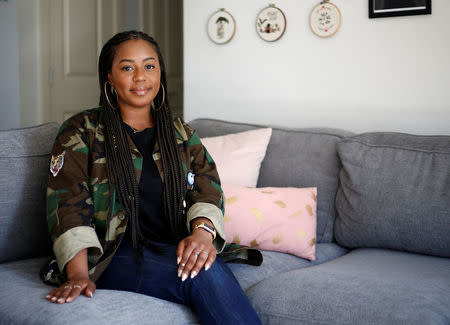 Ishea Brown, who plans to hold a Royal wedding viewing party with 19 of her friends, complete with fascinators and Hennessy, poses for a portrait at her apartment in Seattle, Washington, U.S., May 14, 2018. Picture taken May 14, 2018. REUTERS/Lindsey Wasson