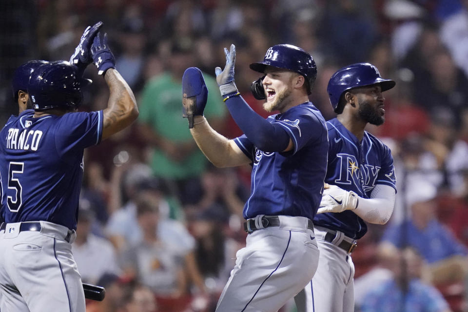 Tampa Bay Rays' Austin Meadows celebrates with Wander Franco after being driven home on a single by Francisco Mejia during the ninth inning of the team's baseball game against the Boston Red Sox at Fenway Park, Tuesday, Aug. 10, 2021, in Boston. At right is Randy Arozarena. (AP Photo/Charles Krupa)