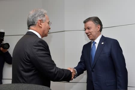 Colombian former President Alvaro Uribe (L) greets President Juan Manuel Santos at Narino Palace in Bogota, Colombia, October 5, 2016. Colombian Presidency/Handout via Reuters.