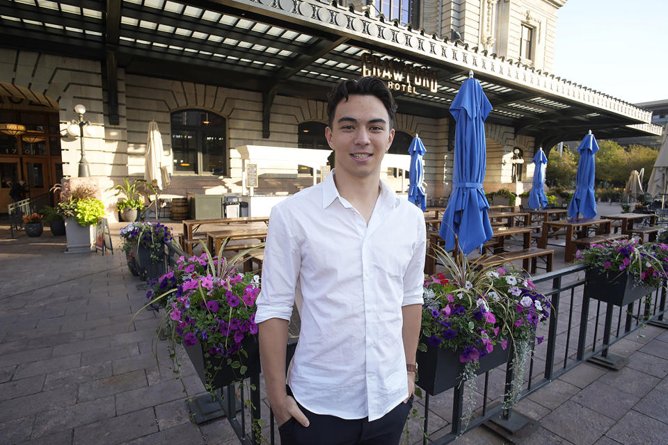 Ronan Takizawa, a student at Colorado College in Colorado Springs, Colo., is shown outside Union Station on the way to boarding a bus for his 65-mile commute to class from downtown Denver early Monday, Aug. 7, 2023, in Denver. (AP Photo/David Zalubowski)