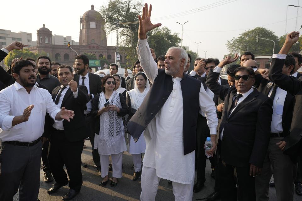 Supporters of former Prime Minister Imran Khan's party chant slogans while they block a road as a protest against the election commission's decision, in Islamabad, Pakistan, Friday, Oct. 21, 2022. Pakistan’s elections commission on Friday disqualified former Prime Minister Imran Khan from holding public office for five years, after finding he had unlawfully sold state gifts and concealed assets as premier, officials said. (AP Photo)