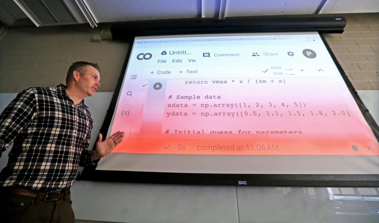 University of Wisconsin-Madison Professor Paul Stoy shows student an example of ChatGPT, new Al-powered technology, Friday in his class. Stoy asked the program to write a code to model data that is not linear. The program came close, Stoy said. "You would need to change a few things to get a perfect score," he said.