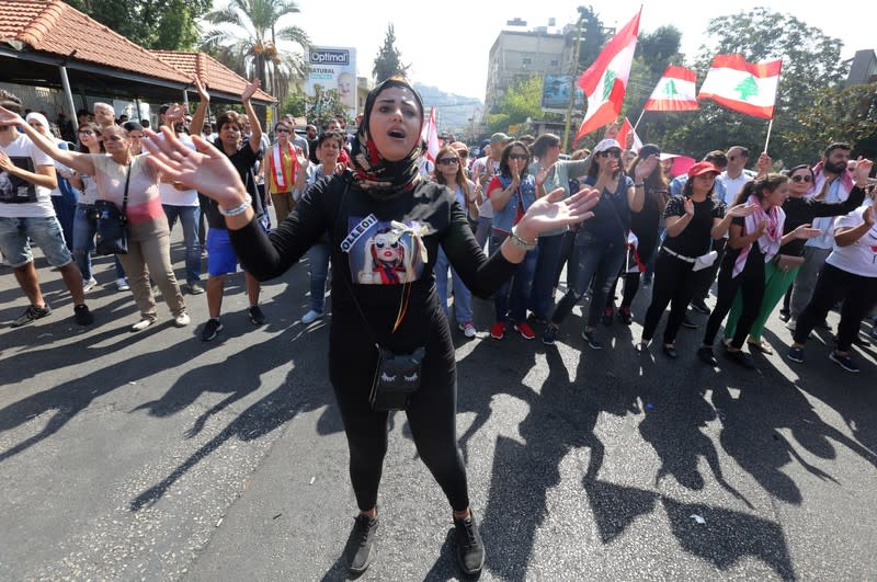 Demonstrators march during an anti-government protest in the southern city of Tyre, Lebanon