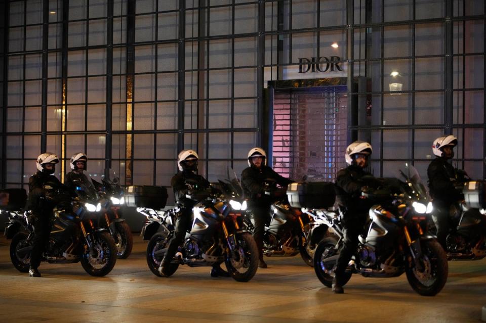 Police officers on motorcycles patrol on the Champs Elysees in Paris (Copyright 2023 The Associated Press. All rights reserved.)