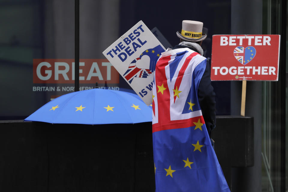 FILE -Pro-EU demonstrator Steve Bray props banners outside the conference centre in Westminster where trade talks between the UK and the EU continue in London, Friday, Dec. 4, 2020 . Britain’s departure from the European Union, triggered by a 2016 referendum and completed in 2020, was the country’s most seismic, and divisive, act in decades. Yet it has featured little in the election campaign. (AP Photo/Kirsty Wigglesworth, File)