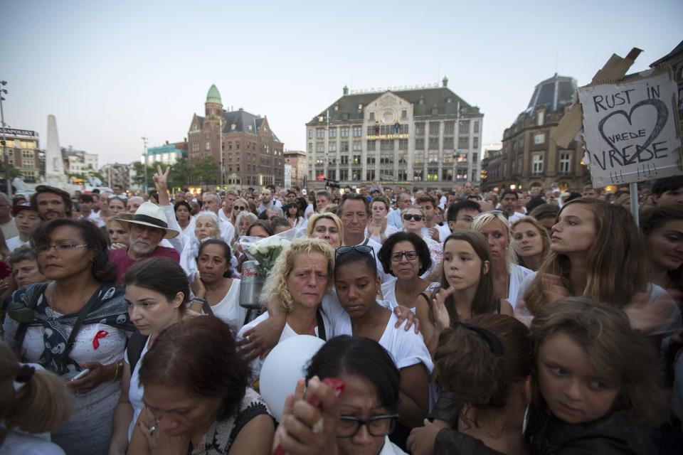 People pay their respects during a national day of mourning for the victims killed in Malaysia Airlines Flight MH17 plane disaster, in Amsterdam in this July 23, 2014 file photo. All 298 passengers and crew - two-thirds of them Dutch - were killed. The Dutch government, a leading Russian trading partner, still hesitates to call it an attack. Attempts to recover parts of the aircraft and human remains have repeatedly been called off due to fighting on the ground. Families also say the Dutch government is not giving them enough information. One law firm has said it is preparing to sue the government for negligence over its handling of the case. REUTERS/Cris Toala Olivares/Files (NETHERLANDS - Tags: TRANSPORT DISASTER)