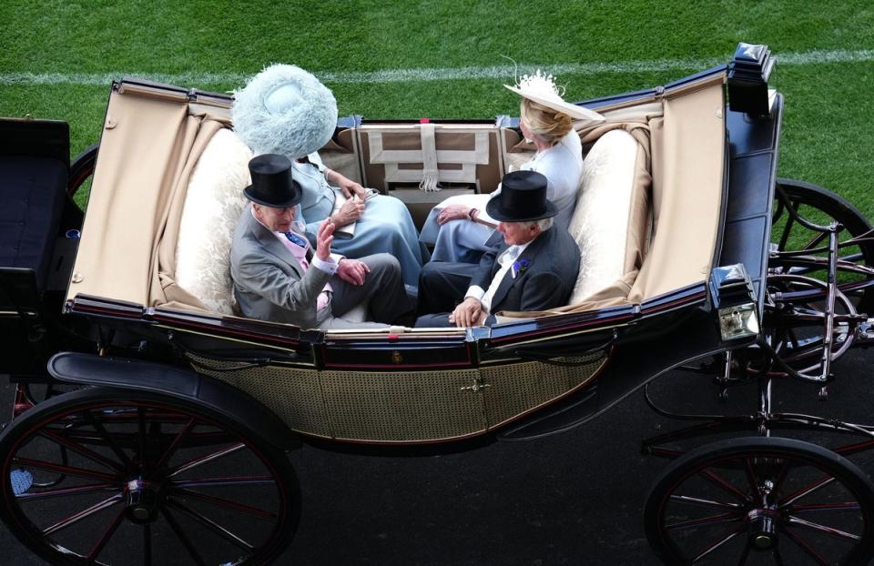 King Charles III and Queen Camilla arrive by carriage in the company of Lord and Lady Bamford (John Walton/PA Wire)