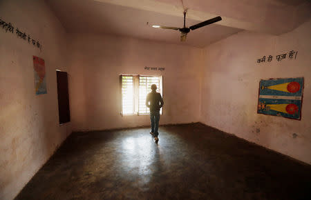 A staff member walks inside an empty classroom at a school in Chingrawati village in Bulandshahr district Uttar Pradesh, India December 5, 2018. REUTERS/Adnan Abidi