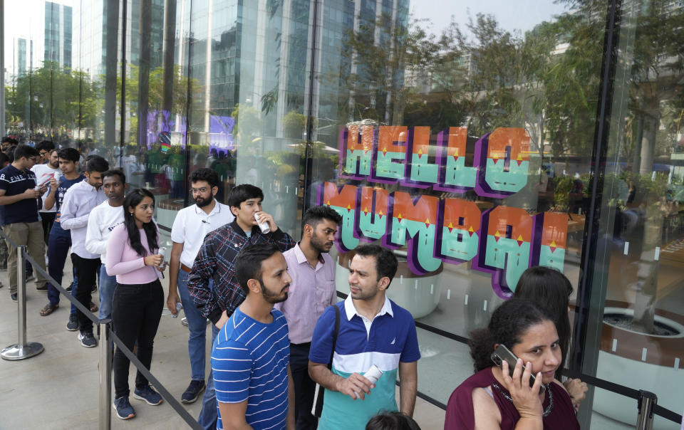 Dozens of people lined up outside for the grand opening Apple Inc. first flagship store in Mumbai, India, Tuesday, April 18, 2023. Apple Inc. is set to open its first flagship store in India in a much-anticipated launch Tuesday that highlights the company's growing aspirations to expand in the country it also hopes to turn into a potential manufacturing hub. (AP Photo/Rafiq Maqbool)