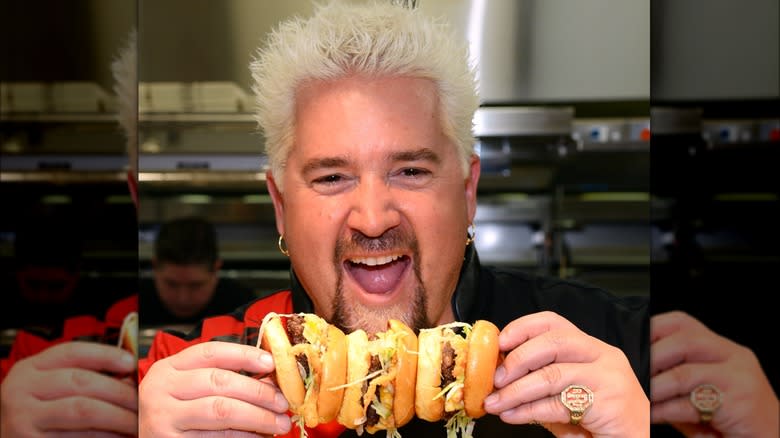 Guy Fieri with row of burgers 