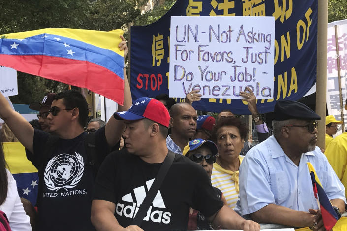 In this Sept. 24, 2019 photo, opponents of Venezuelan President Nicolas Maduro protest outside of United Nations headquarters in New York. Two separate diplomatic delegations represented Venezuela at the U.N. General Assembly this year, shadowing and circling each other in a fierce fight for international recognition as the country reels from an economic collapse and political uncertainty. (AP Photo/Alexandra Olson)