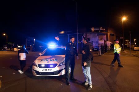 Police set up a cordon outside the Manchester Arena in northern England where U.S. singer Ariana Grande had been performing in Manchester, Britain, May 22, 2017. REUTERS/Jon Super