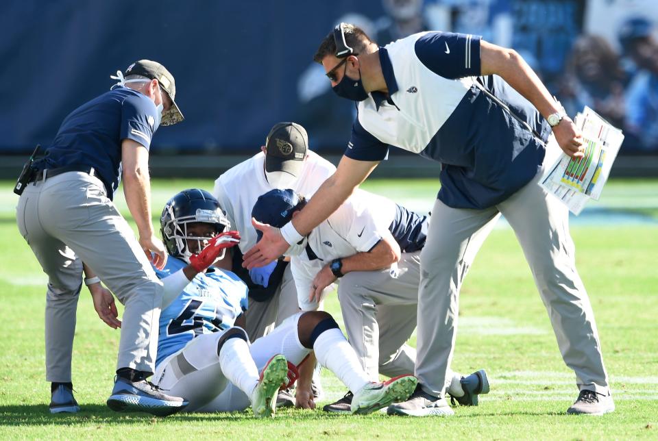 Tennessee Titans defensive back Joshua Kalu (46)
 is helped up by head coach Mike Vrabel after an injury during the third quarter at Nissan Stadium Sunday, Nov. 8, 2020 in Nashville, Tenn.