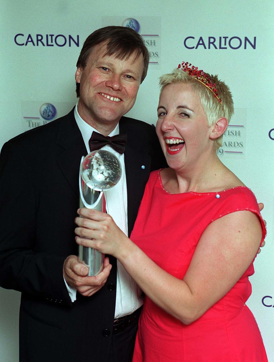 Coronation Street actors David Nielson, who plays Roy Cropper, and Julie Hesmondhalgh, who plays Hayley  Patterson, hold the award on behalf of the programme for being chosen Best Soap by TV viewers, at the Carlton TV's British Soap Awards 1999.   (Photo by Michael Crabtree - PA Images/PA Images via Getty Images)