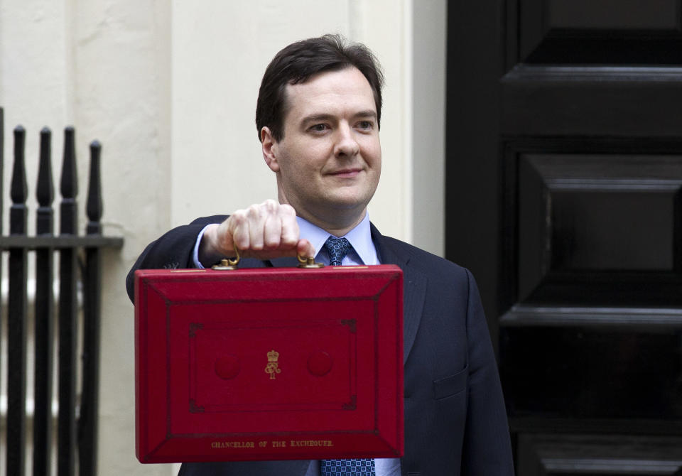 Britain's Chancellor of the Exchequer George Osborne poses for the media with his traditional red dispatch box outside his official residence at No 11 Downing Street in London, as he departs to deliver his annual budget speech to the House of Commons, Wednesday, March 21, 2012. Later on Wednesday, George Osborne, the U.K.'s finance minister, will unveil his budget, the annual update of the state of the country's economy and the coalition government's plans for taxation and spending for the year. This time round, attention has focused on what Osborne is going to do with the "50p" tax, political shorthand for the 50 percent top-rate income tax, on annual income above 150,000 pounds ($238,000). (AP Photo/Matt Dunham)