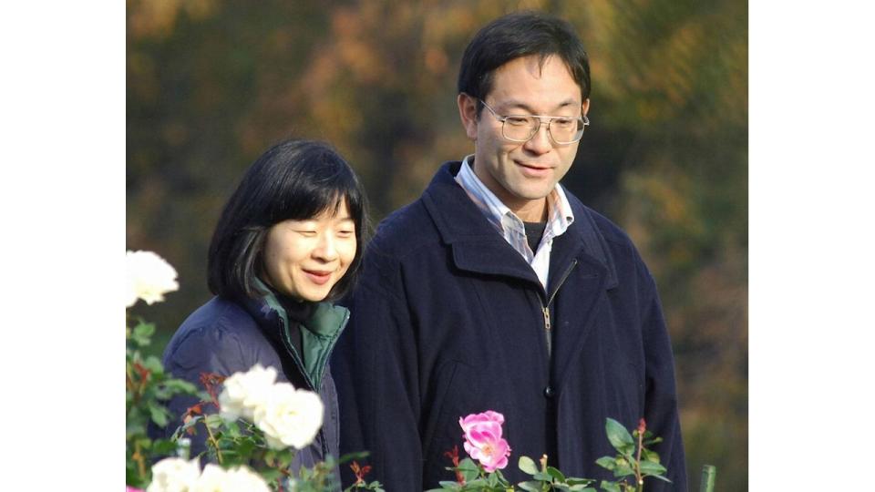 Sayako Kuroda and Yoshiki Kuroda walking through a flower garden