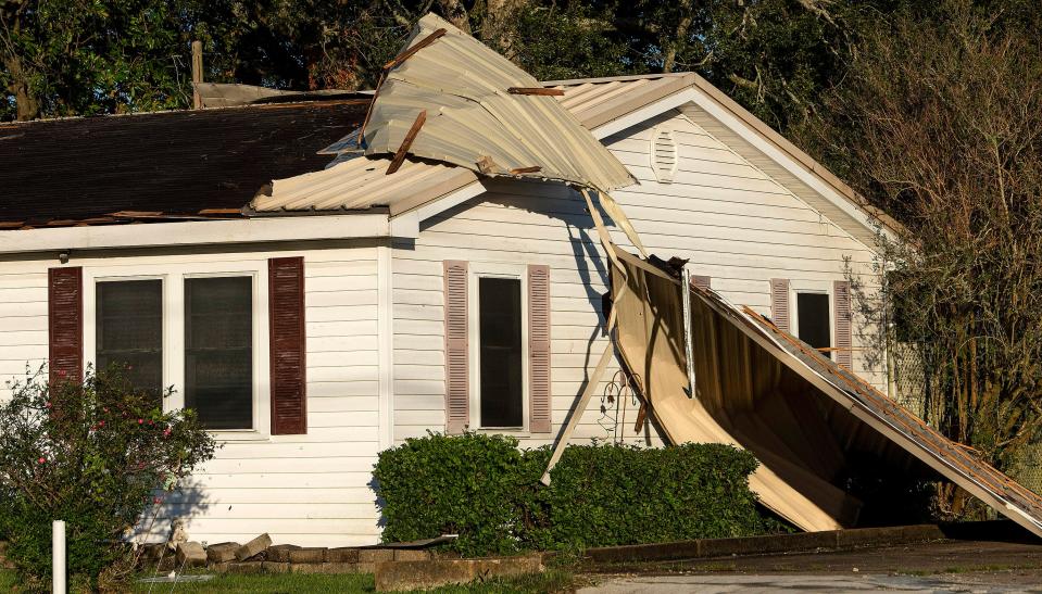 A metal roof is peeled off of a house in New Iberia, Louisiana, on Saturday morning.  Oct. 10, 2020