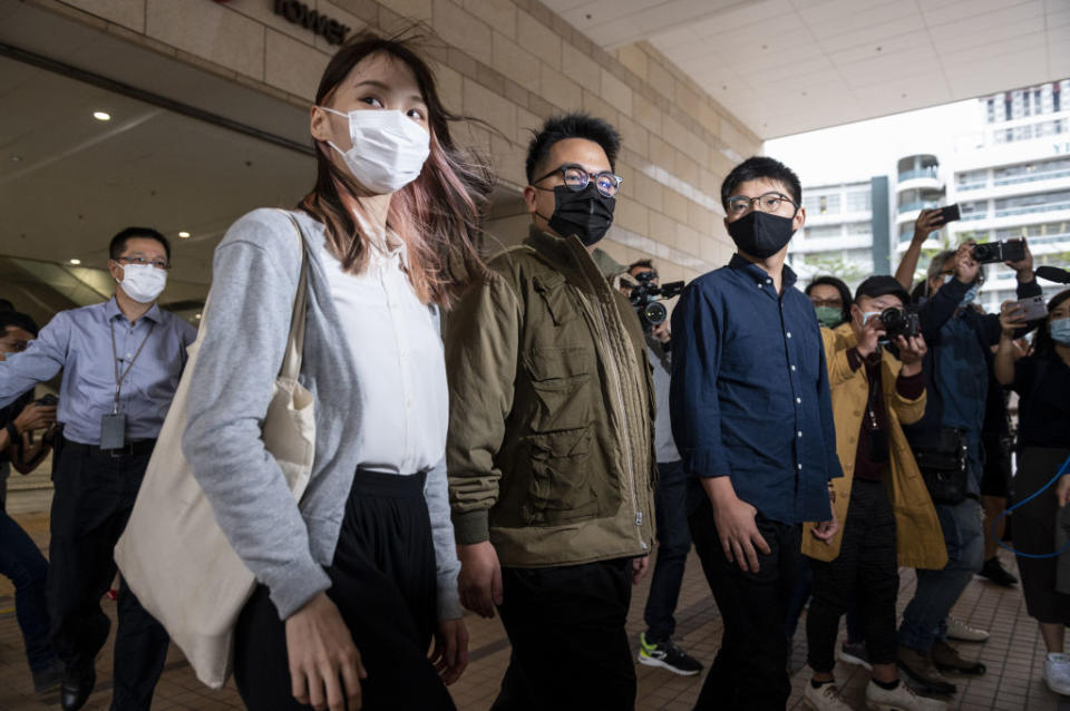 Agnes Chow (L), Ivan Lam (C), and Joshua Wong (R) arrive at the West Kowloon Law Courts building on Nov. 23, 2020 in Hong Kong.<span class="copyright">Miguel Candela Poblacion—Anadolu Agency/Getty Images</span>