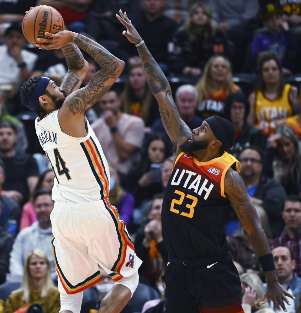 New Orleans Pelicans forward Brandon Ingram (14) shoots over Utah Jazz forward Royce O'Neale (23) during the first half of an NBA basketball game Friday, Nov. 26, 2021, in Salt Lake City. (AP Photo/Alex Goodlett)