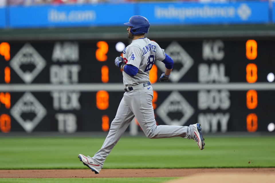 Los Angeles Dodgers' J.D. Martinez runs to second after hitting an RBI-double off Philadelphia Phillies' Ranger Suarez during the first inning of a baseball game, Friday, June 9, 2023, in Philadelphia. (AP Photo/Matt Rourke)