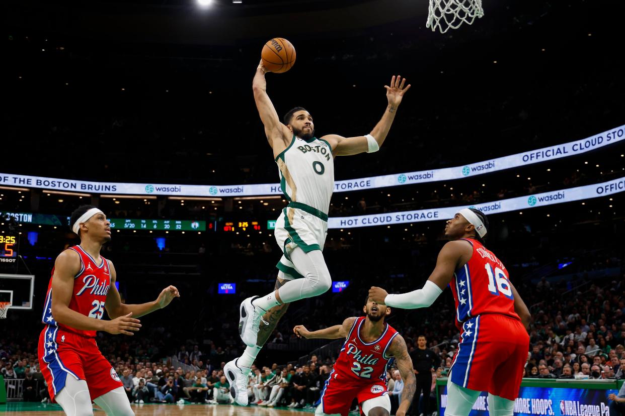 Celtics forward Jayson Tatum (0) goes in for a dunk as Philadelphia 76ers forward Darius Bazley (25) and guard Ricky Council IV (16) look on at TD Garden on Tuesday.