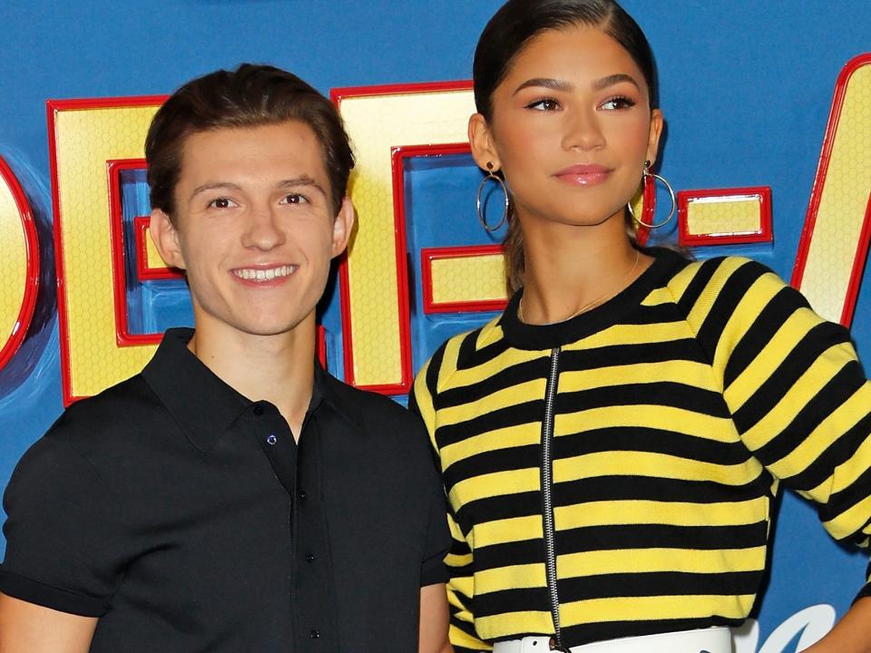 Tom Holland and Zendaya posing together on a red carpet in 2017.