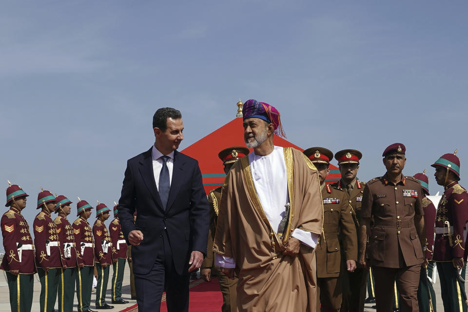 In this photo released by the official Syrian state news agency SANA, Omani Sultan Haitham bin Tariq, center right, receives Syrian President Bashar Assad, center left, upon his arrival in the capital Muscat, Oman, Monday, Feb. 20, 2023. Assad visited the gulf nation of Oman Monday on his first official visit since the deadly Feb. 6 quake, his office said. (SANA via AP)