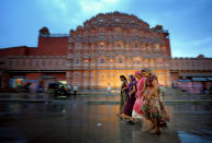 I thought this would be a good place for pictures, so I returned during the evening on my second night in Jaipur. I got lucky with the rain because it made for interesting reflections, and I had a good time trying to capture the chaotic motion on the streets of Jaipur. Hawa Mahal (The Palace of Winds) is pictured in the background. (Photo and caption by Edward Graham/National Geographic Traveler Photo Contest) <br> <a href="http://travel.nationalgeographic.com/travel/traveler-magazine/photo-contest/2013/" rel="nofollow noopener" target="_blank" data-ylk="slk:See more and submit;elm:context_link;itc:0;sec:content-canvas" class="link ">See more and submit</a>