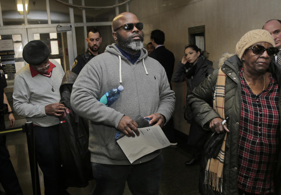 Friends and family of Timothy Caughman, including his cousin Richard Peek, center, leave the courtroom after the sentencing of James Jackson in New York, Wednesday, Feb. 13, 2019. Jackson, a white supremacist, pled guilty to killing Caughman, a black man, with a sword as part of a racist plot that prosecutors described as a hate crime. Peek read a victim impact statement during the sentencing. (AP Photo/Seth Wenig)