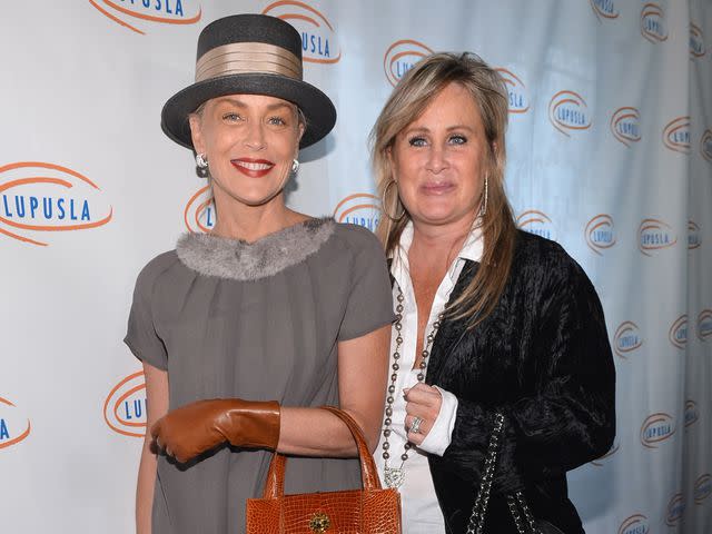 <p>Alberto E. Rodriguez/Getty</p> Sharon Stone and sister Kelly Stone arrive to the Lupus LA 10th Anniversary Hollywood Bag Ladies Luncheon on November 1, 2012.