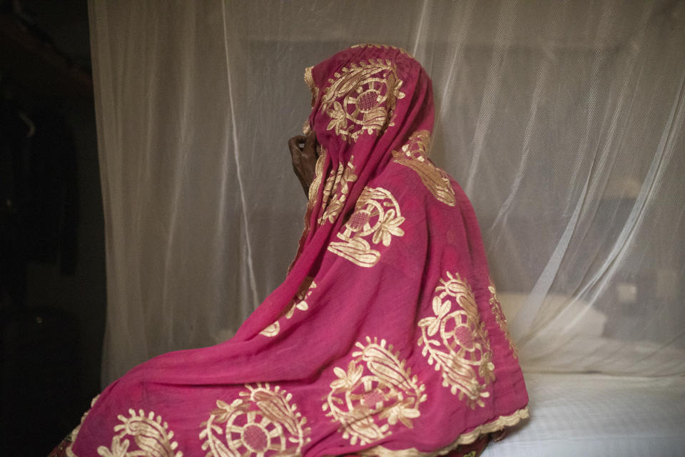 The mother of a 16-year-old named Adama sits in Burkina Faso in this 2023 photo. Adama’s mother heard about her son’s seizure from a relative who saw him grabbed by security forces. A video of Adama's killing began circulating on WhatsApp chat groups around Feb. 14. A few days later, the teen’s body was found on a roadside near the military base where the video was filmed. (AP Photo)