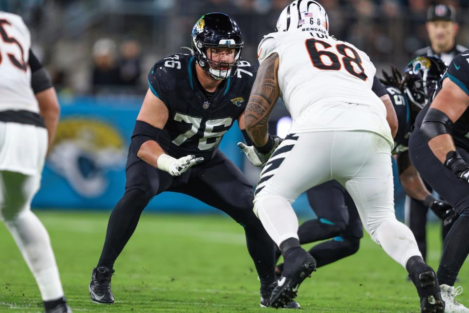 Jacksonville Jaguars guard Ezra Cleveland (76) in action during an NFL football game against the Cincinnati Bengals, Monday, Dec. 4, 2023, in Jacksonville, Fla. (AP Photo/Gary McCullough)