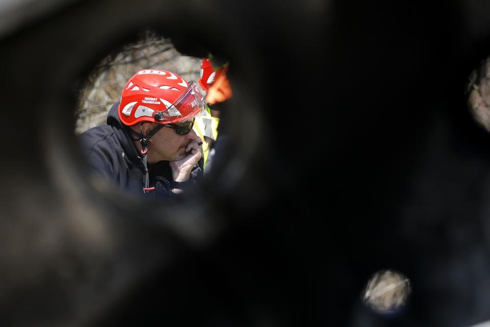 A hazmat technician is seen through a hole in debris from the Seqens/PCI Synthesis plant, Friday, May 5, 2023, in Newburyport, Mass. The pharmaceutical plant where a powerful blast killed a Massachusetts worker has moved into the cleanup phase. (AP Photo/Michael Dwyer)