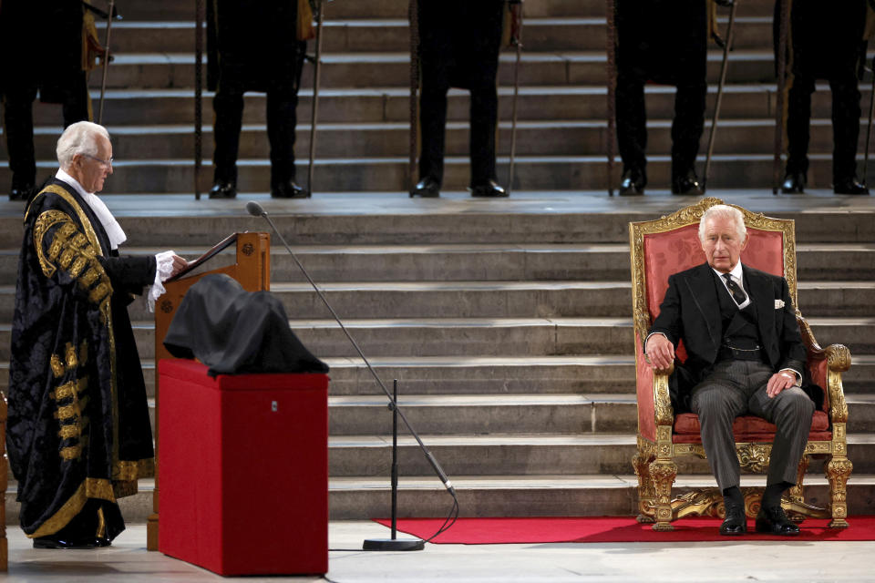 Lord Speaker John McFall, left, makes an address as Britain's King Charles III sits at Westminster Hall, where both Houses of Parliament are meeting to express their condolences following the death of Queen Elizabeth II, at Westminster Hall, in London, Monday, Sept. 12, 2022. Queen Elizabeth II, Britain's longest-reigning monarch, died Thursday after 70 years on the throne. (John Sibley/Pool Photo via AP)