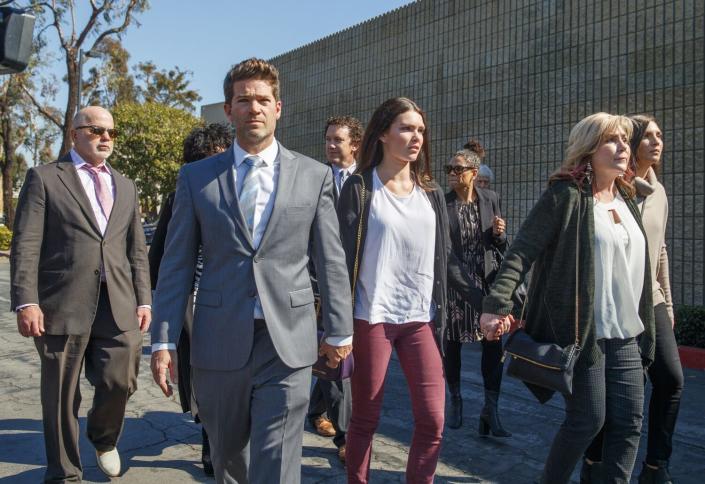 Defense attorney Philip Cohen, left, Grant Robicheaux, center, and his girlfriend Cerissa Riley walk outside with others