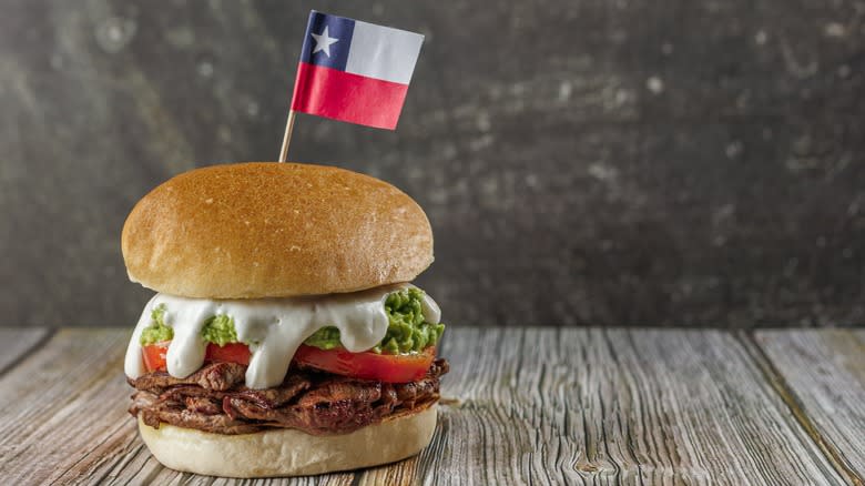 Burger with Chilean flag on wooden table 