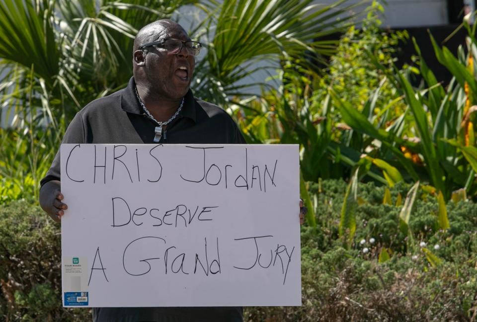Fort Myers resident Calvin Church holds a signs while protesting in downtown Fort Myers Friday afternoon, March 15, 2024. Members of the Lee County NAACP held a rally in front of the office of the state attorney to protest the handling of the Fort Myers Police Department fatal shooting of Christopher Jordan on December 1, 2023.
