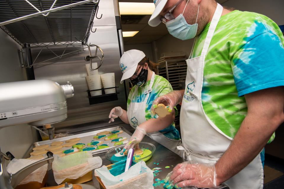 Erin Campbell, left, and Trey Koller work together decorating sugar cookies to serve at Bake Ability in Buckingham on Friday, May 7, 2021. [MICHELE HADDON / PHOTOJOURNALIST]