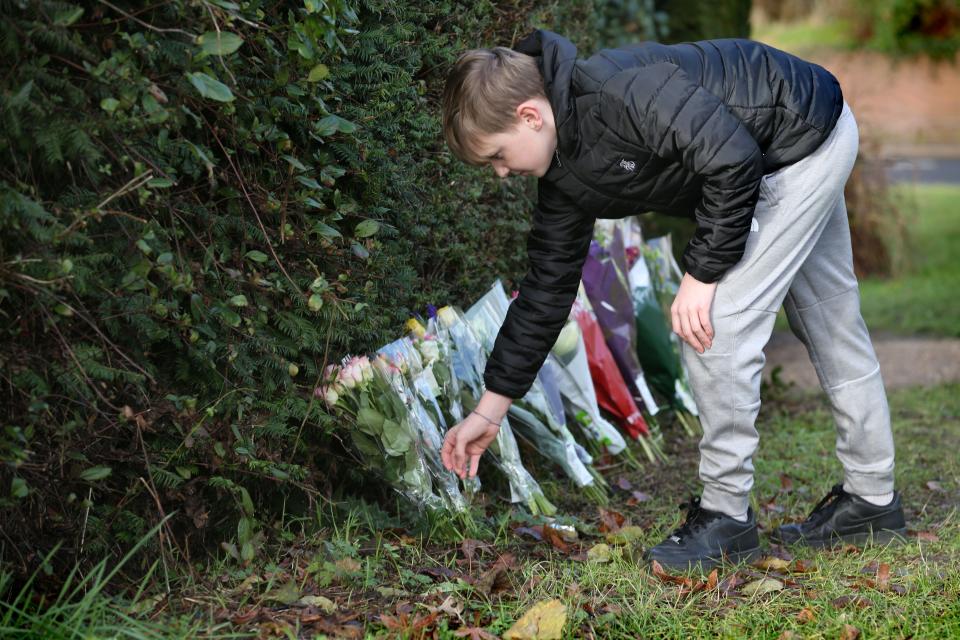 A young person leaves flowers for mother who disappeared (Getty Images)